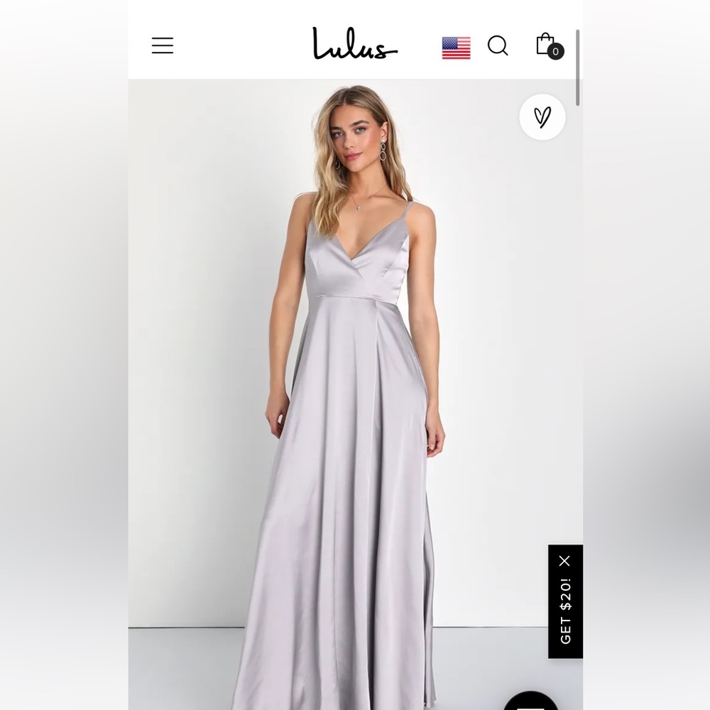 Floor length sleeveless dress with a slit. Color is cream/peach